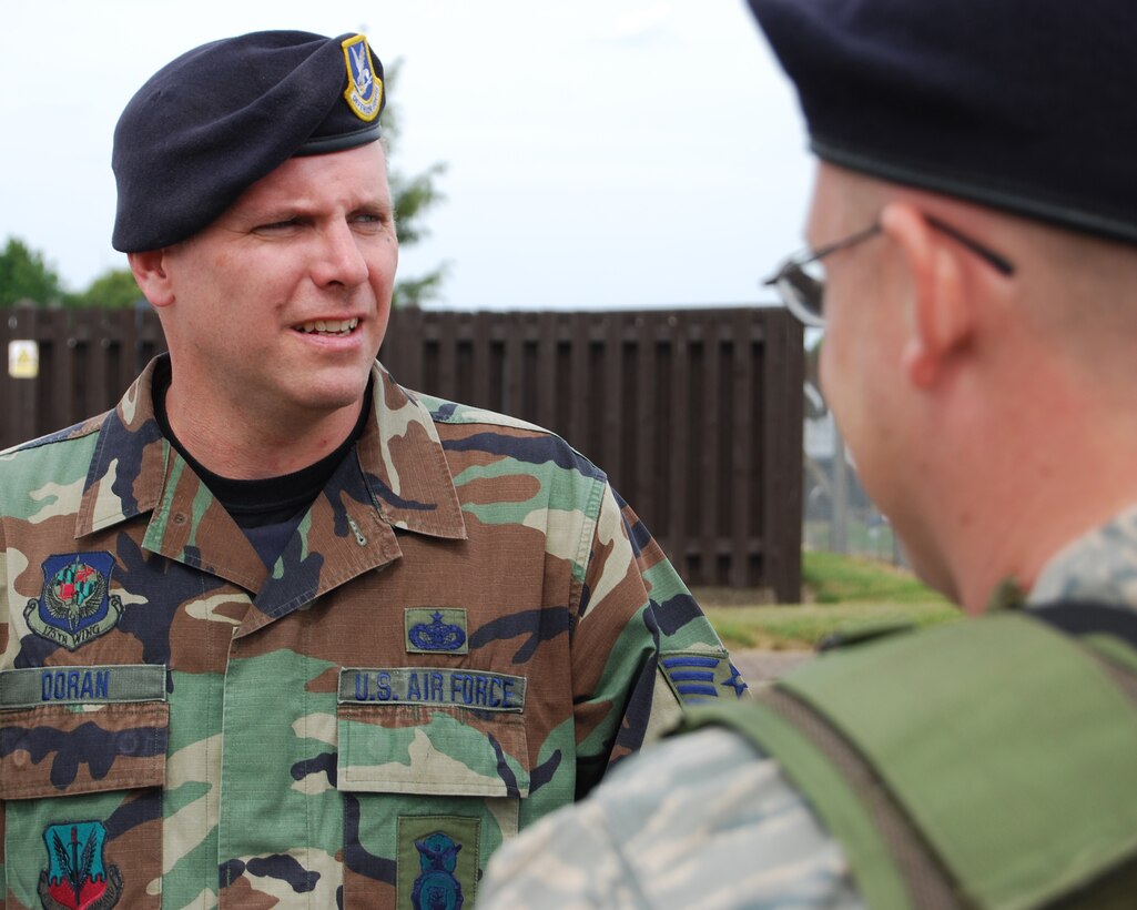 Tech. Sgt. Charles Doran, 175th Security Forces Squadron, Maryland Air National Guard, speaks with his patrol partner. Staff Sgt. Andrew Curtis (right) from the 48th Security Forces, RAF Lakenheath is in the foreground.  Sergeant Doran is deployed to USAFE at RAF Lakenheath for annual training.  June 24, 2008 (U.S. Air Force Photo by Senior Master Sgt. Bill Harkum)
