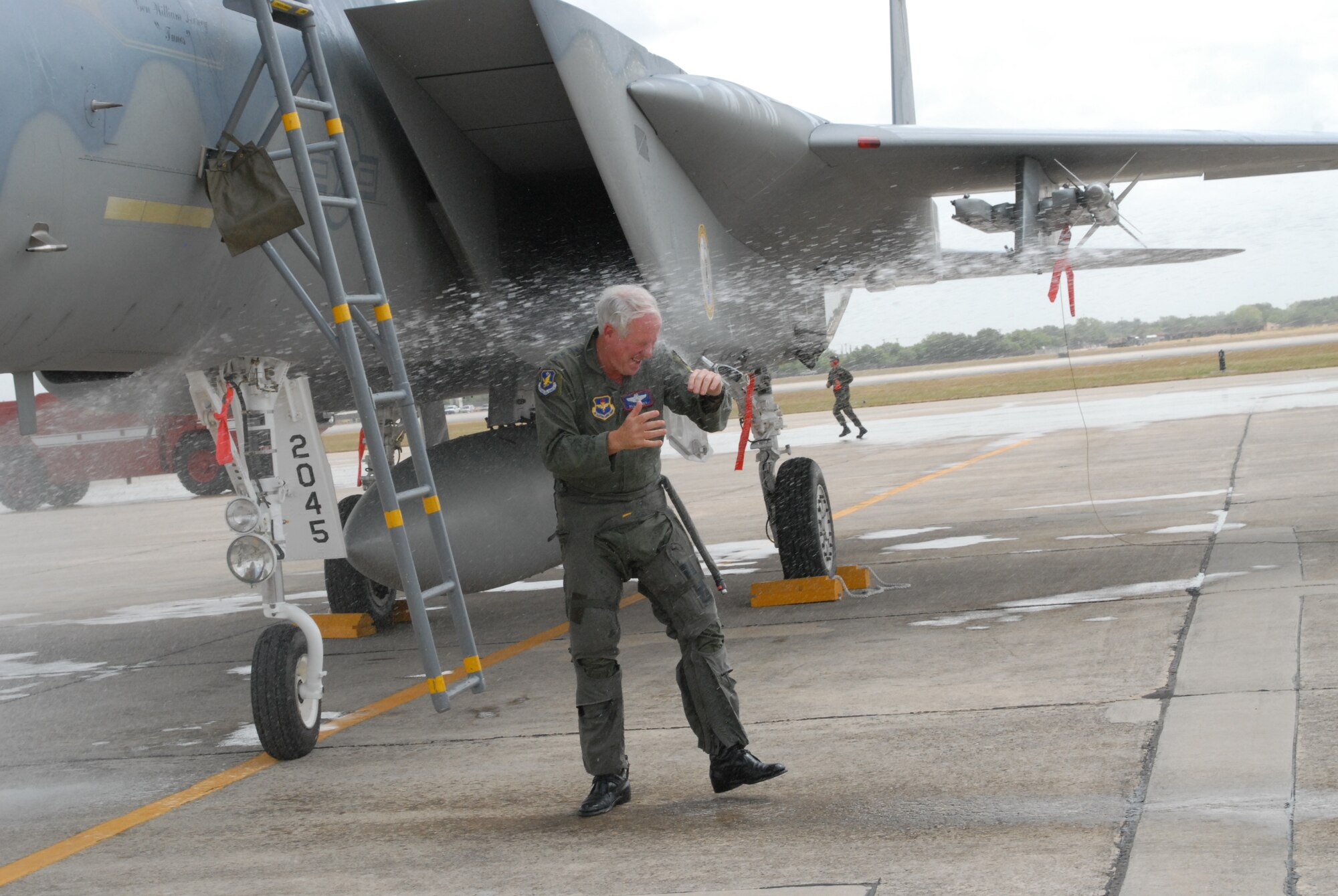 Gen. William R. Looney, Commander, Air Education and Training Command, was honored by fellow Airmen, friends and family during his final, or "fini," flight July 1. General Looney selected an F-15 aircraft as his last flight and was honored by firefighters dousing him with hundreds of gallons of water and friends and family showering him with warm wishes for his retirement. (U.S. Air Force photo by Rich McFadden)