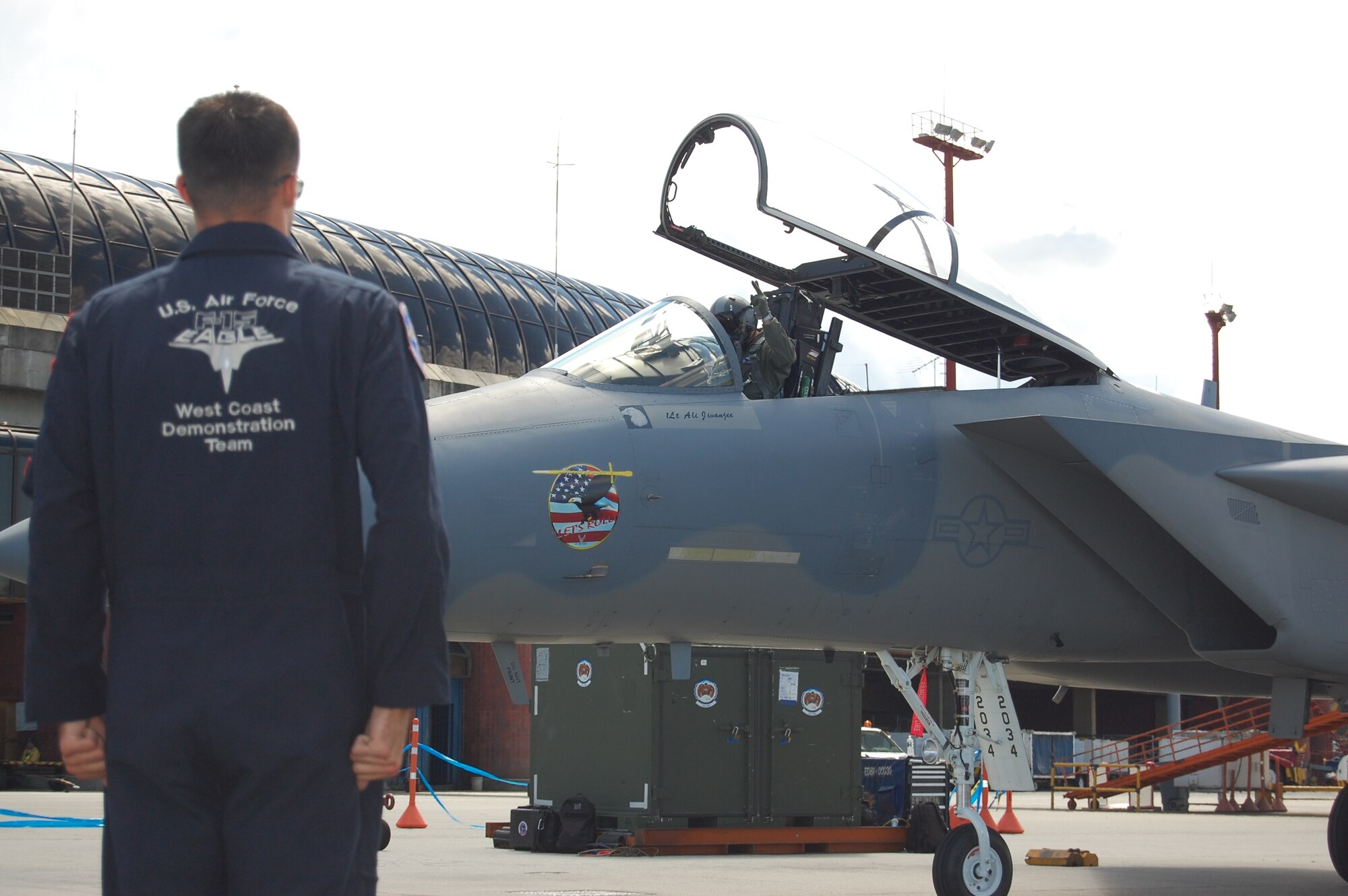 Staff Sgt. Darren Pautz, an F-15 crew chief with the F-15 West Coast Demonstration Team performs pre-flight communications with the pilot, Capt. Sam Joplin, during the RIO NEGRO air and trade show in Medellín, Colombia. The Demonstration Team celebrated 25 years of service during RIO NEGRO by performing for audiences at the Medellín International Airport for six days, thrilling an audience estimated at more than 100,000 Colombian citizens. (Photo by Capt. Nathan Broshear) 