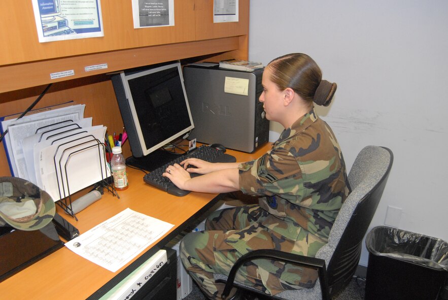 Airman 1st Class Mackenzie Castaldo, 43rd Medical Support Squadron, looks over medical records at the Tricare Release of Information office. (U.S. Air Force Photo by Emily Smith)