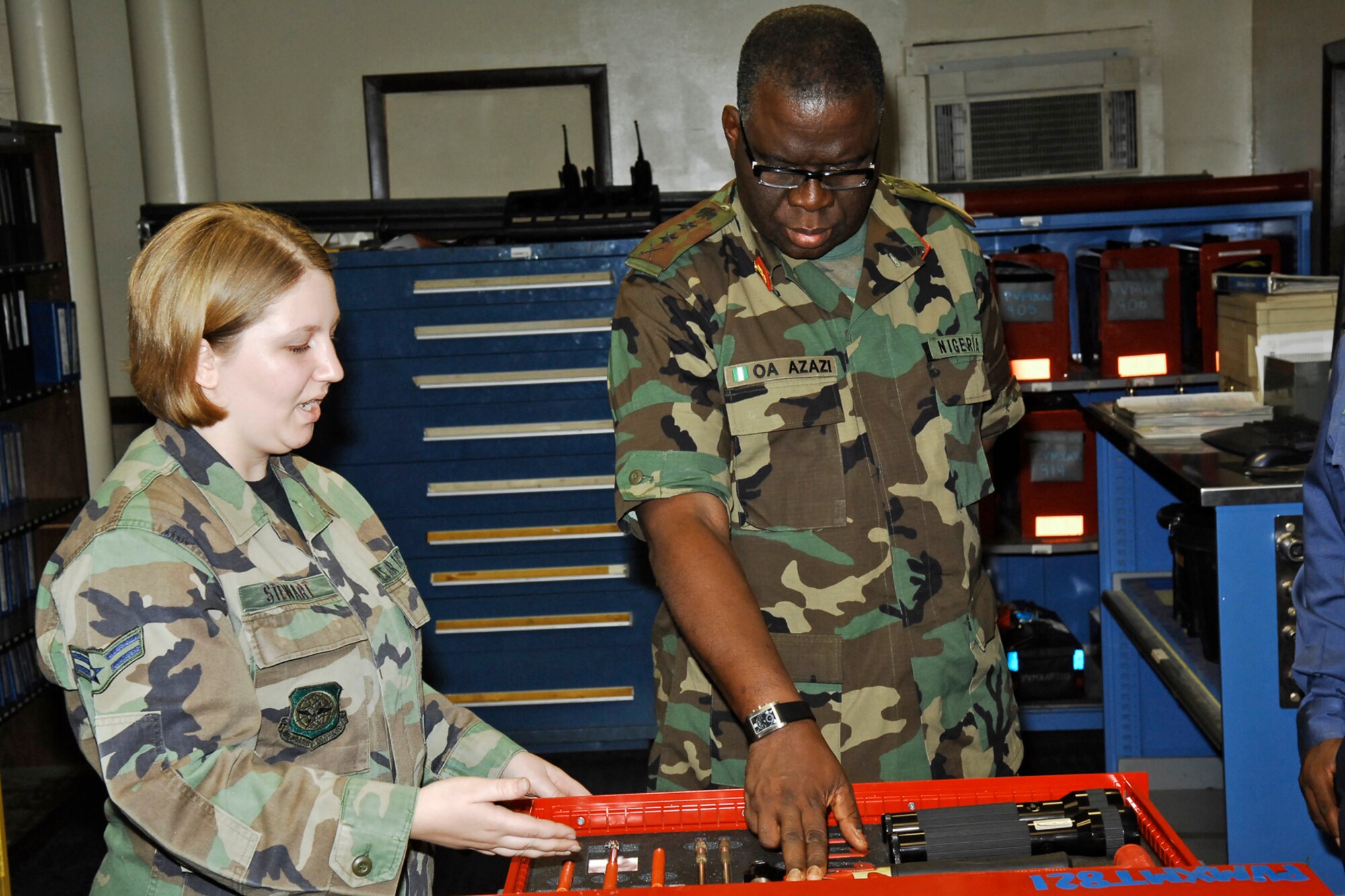 Airman 1st Class Sara Stewart, 43rd Maintenance Squadron, talks to General Owoye Azazi, Chief of Defense Staff in Nigeria, about how maintainers account for tools using cut-outs and tool boxes during a visit June 26. General Azazi visited Pope and neighboring Fort Bragg as part of a tour of the United States.  (U.S. Air Force Photo by Mike Murchison)