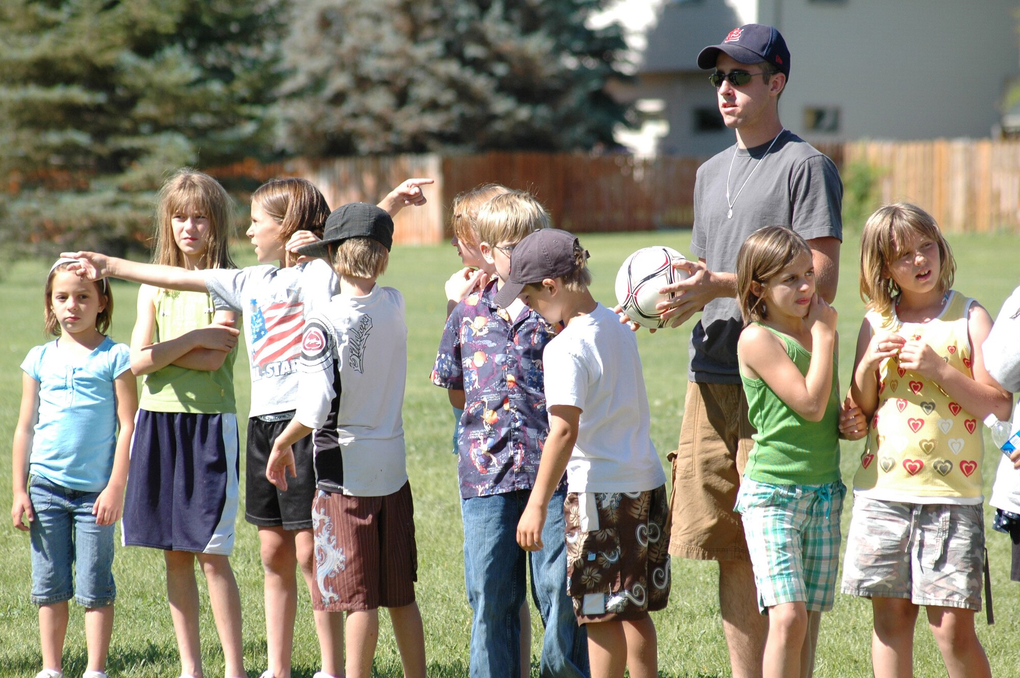Airman 1st Class Brandon Connors stands near his team of Great Falls Community Recreation Center children June 27 before a game at Montana Park in Great Falls June 27. (U.S. Air Force photo/ Airman 1st Class Dillon White)