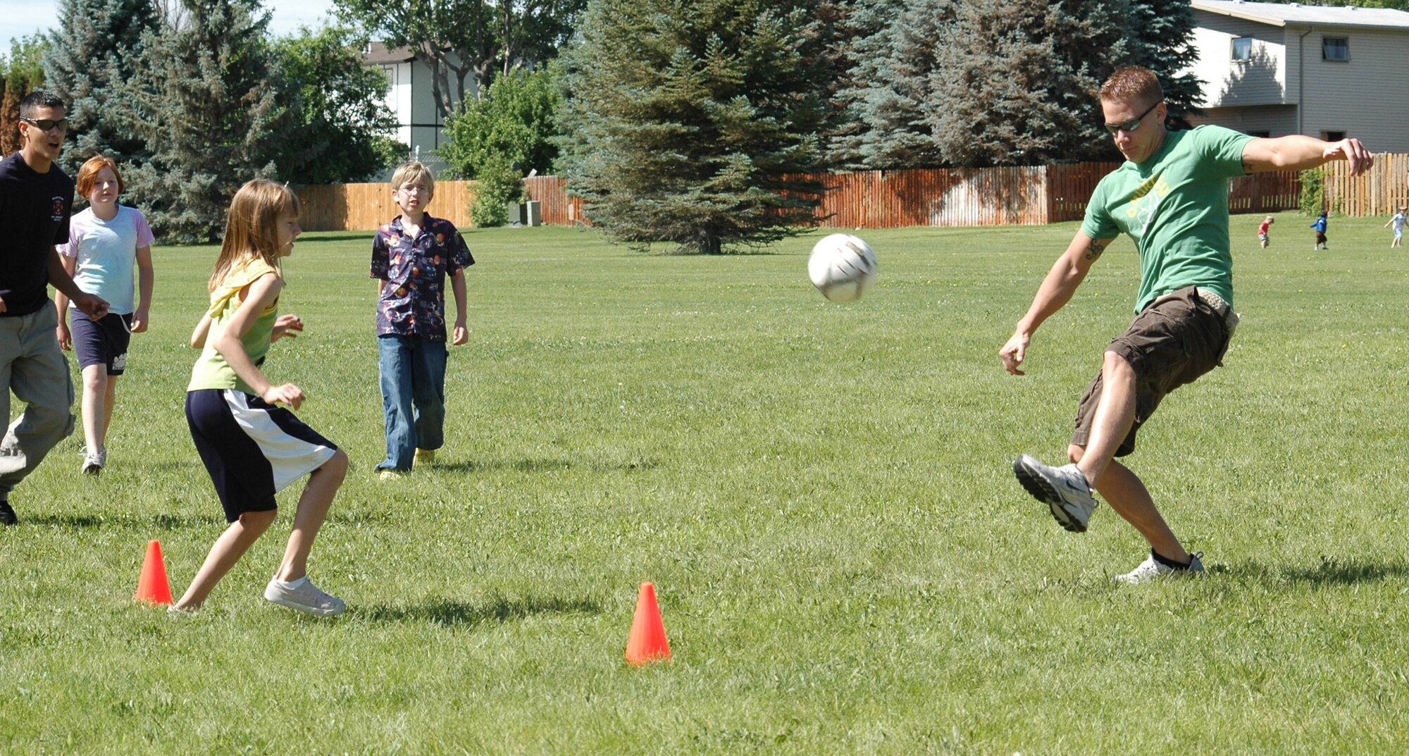 Airman 1st Class Erik Chittick, 341st Civil engineer Squadron firefighter,  plays soccer with local area youth at Montana Park in Great Falls June 27 as a volunteer with the Great Falls Recreation Center. (U.S. Air Force photo/ Airman 1st Class Dillon White) 