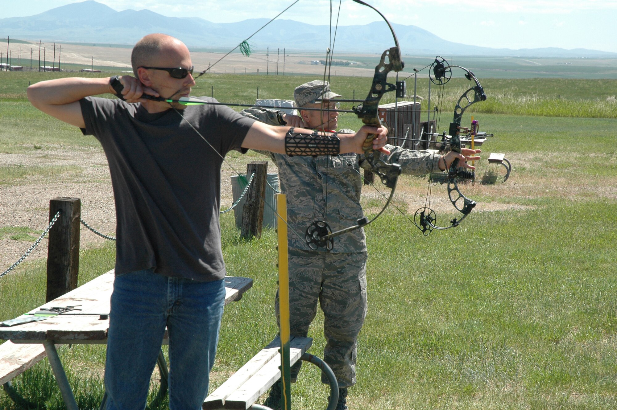 Darrell Beach (left) and Tech. Sgt. Matthew Sutton (right) take aim at targets at the Eastside Archery Club on the southwest  side of Malmstrom. The club is looking for new members. (U.S. Air Force photo/Airman 1st Class Dillon White)
