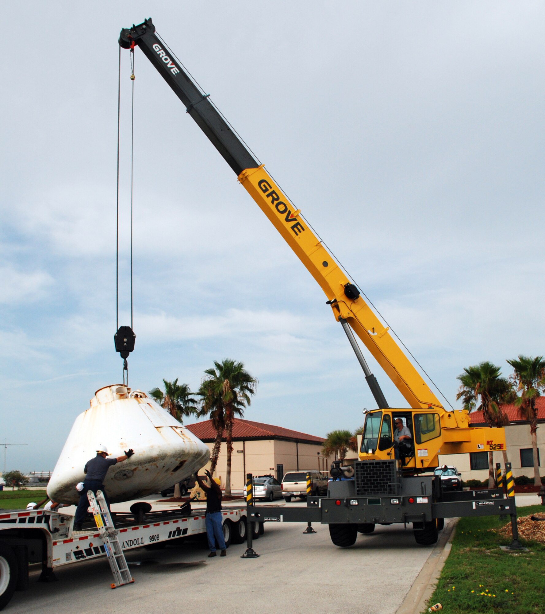 Workers at Patrick Air Force Base, Fla., help guide the 9,000-pound Apollo Boilerplate #1206 onto a flatbed truck for transportation to a local refurbishment facility. On loan here to the Air Force Reserve's 920th Rescue Wing from the Smithsonian Institute's Air and Space Museum, the capsule was once used by Air Force rescue units to train for astronaut recovery during the Apollo and Skylab space programs. (U.S. Air Force photo/Capt. Cathleen Snow)