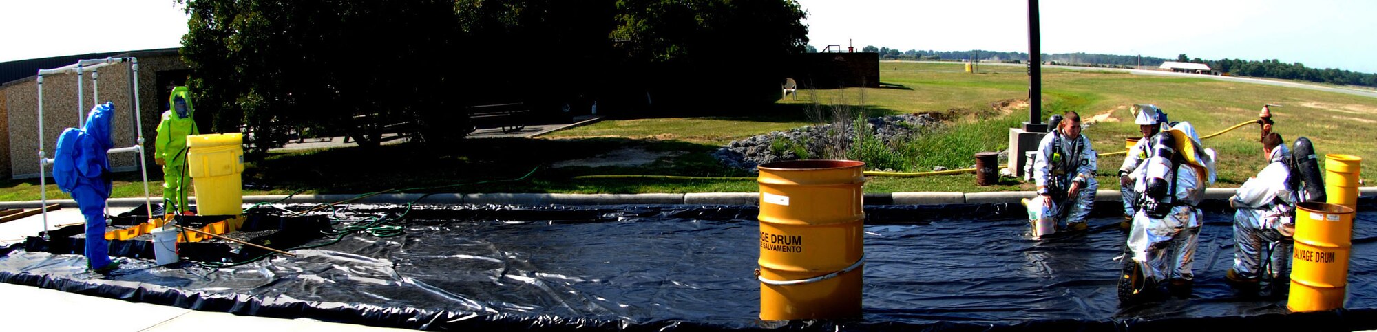 SEYMOUR JOHNSON AIR FORCE BASE, N.C. ? (From left to right) Senior Airmen Brian Garrigan, Airman Anthony Hildebrand, Airman 1st Class Shane Rounds, Airman 1st Class Trevor Williams and Airman 1st Class Cartalo Madison, all from the 4th Civil Engineer Squadron and fire department wait for the hazardous material exercise to start here June 24. The Airmen were working the decontamination line and were responsible for decontamination of patients and other responders. (U.S. Air Force photo by Airman 1st Class Rae Henline)