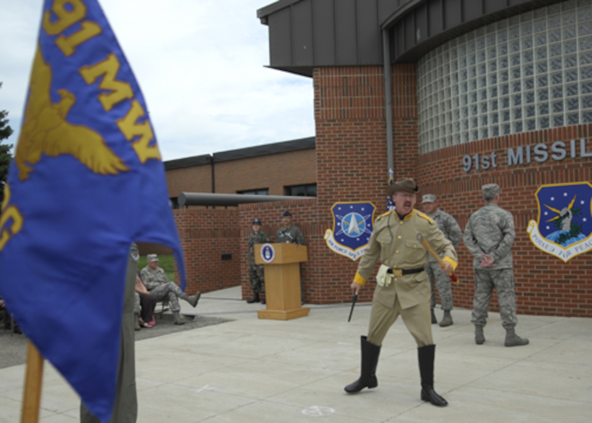 MINOT AIR FORCE BASE, N.D. -- Retired Master Sgt. Dave Larrison, portraying the wing's mascot Teddy Roosevelt, leads a formation of 91st Missile Wing Airmen in a rousing cheer during a redesignation cermony here July 1st. The 91st MW’s mission has been important to the safety and security of our nation for 40 years. (U.S. Air Force photo by Senior Airman Joe Rivera)