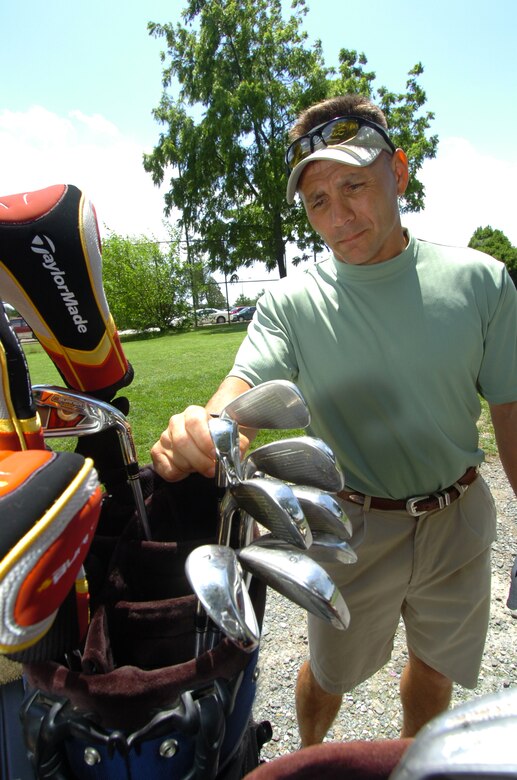 Senior Master Sgt. Kirk Kessler, 316th Civil Engineer Squadron, selects his next club. The Tiger Woods Foundation selected Sergeant Kessler to play in the 2nd Annual AT&T Naional golf tournament July 2. (U.S. Air Force photo by Bobby Jones)