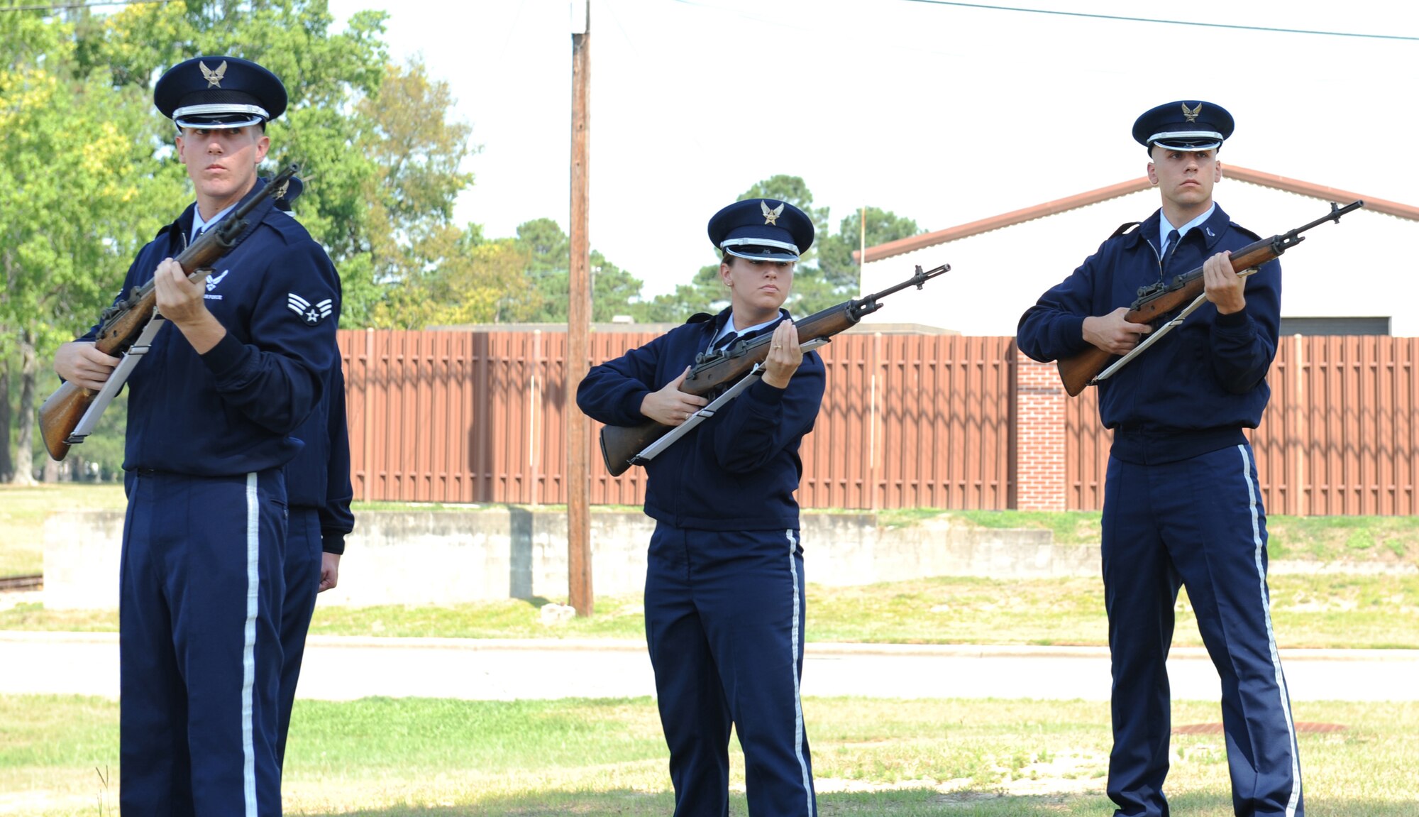 SEYMOUR JOHNSON AIR FORCE BASE, N.C.- Airman 1st Class Jason Hochsprung, Senior Airman Tiffany Legree, and Senior Airman Hoston Kirkeide, members of the firing party, fire their guns as part of a drill practice June 24. The drill practices are an integral part of ensure base honor guard members are prepared to conduct a flawless performance. (U.S. Air Force photo by Airman 1st Class Whitney Stanfield)
