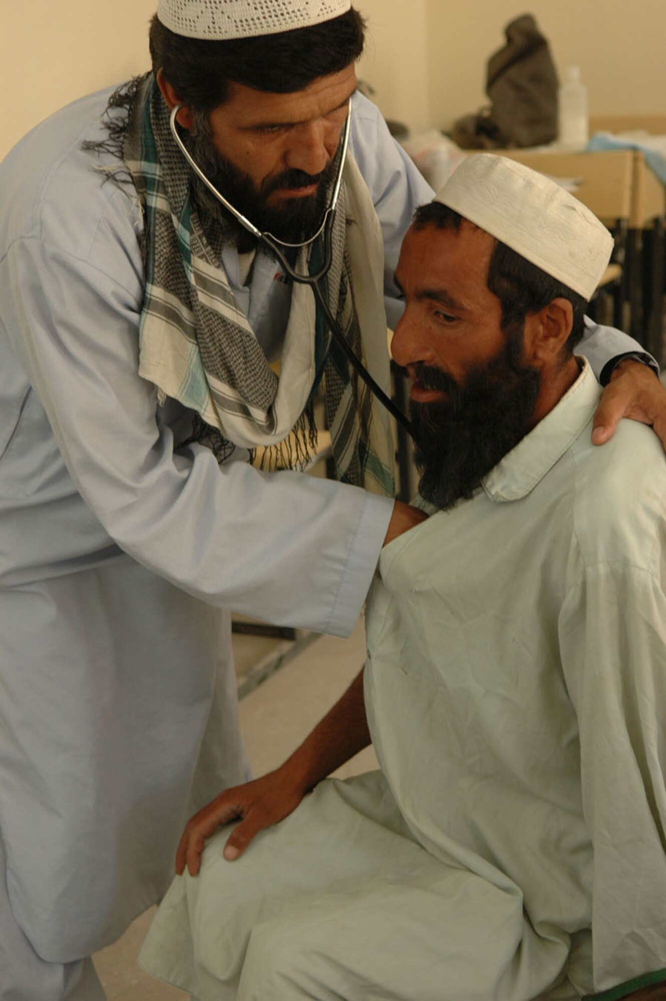 PARWAN PROVINCE, Afghanistan -- A local national receives a check up from a local doctor as part of a Village medical outreach in Nilay Village in the Kohe Sofe District here June 26. (U.S. Army photo by Pvt. Tamara Gabbard)