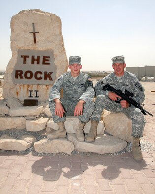 SOUTHWEST ASIA -- Air Force Senior Airman David Green and his father Army Reserve Sgt. Mark Green met June 21 at an air base in Southwest Asia. Airman Green is deployed to the 386th Expeditionary Security Forces Squadron and Sgt. Green is deployed to the 1st Brigade 4th Infantry Division in Iraq. Airman Green was able to spend time with his father before he headed into Iraq for a 13-month tour of duty. (U.S. Air Force photo/Tech. Sgt. Michael O'Connor)