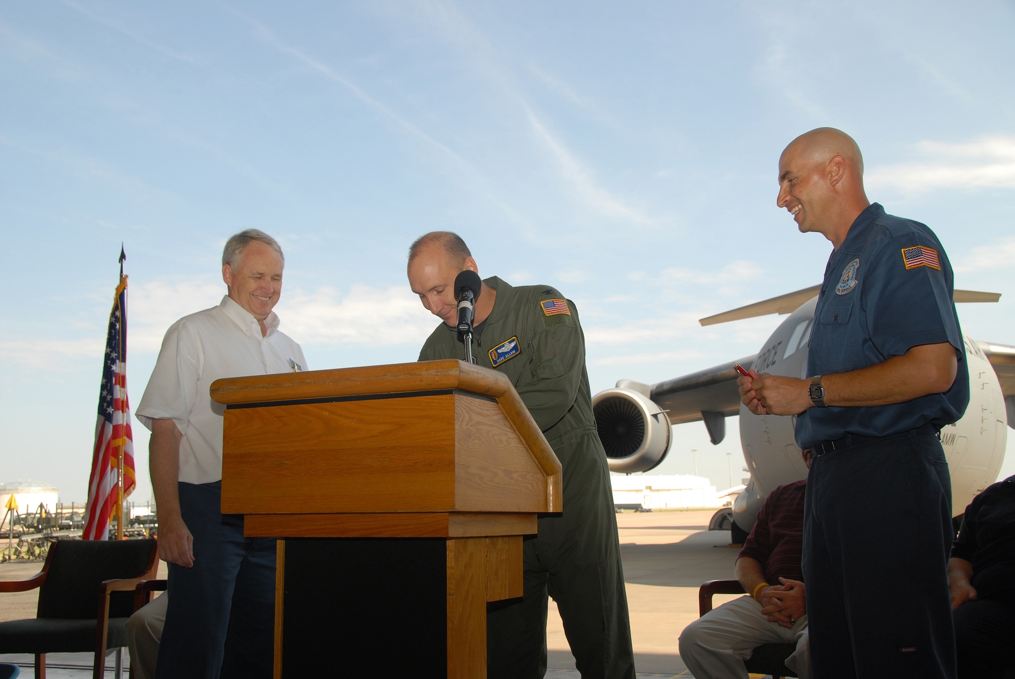 Col. David W. Allvin,97th Air Mobility Wing, signs the Altus Air Force Base agreement, June 30, between the base and Ardmore Valero refining to start the first voluntary protection program in the Air Education and Training Command. Looking on are Altus AFB VPP program members David Fortuna (left) and David Dresser. (U.S. Air Force/A1C Jennifer Flores)