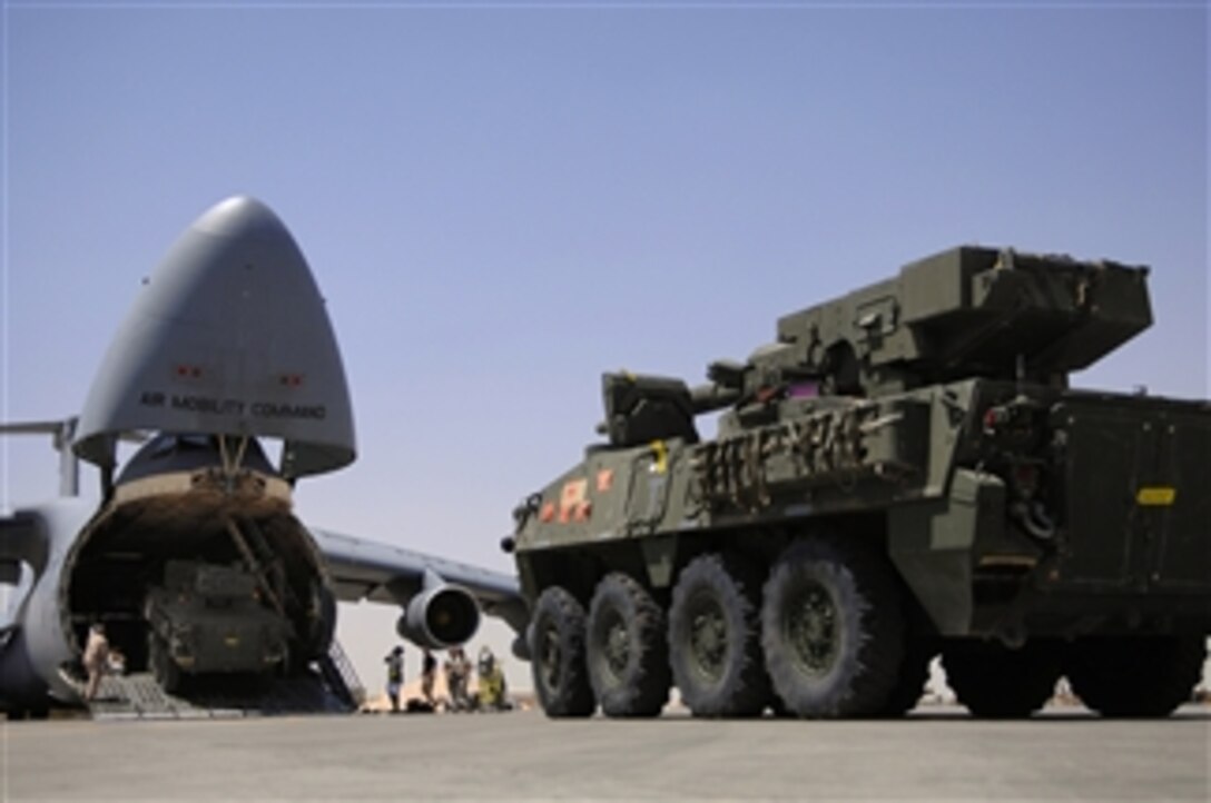 Two U.S. Army Stryker infantry carrier vehicles drive into a C-5 Galaxy aircraft at Joint Base Balad, Iraq, on June 25, 2008.  The C-5 has a "kneeling" landing gear system that permits lowering of the parked aircraft so the cargo floor is at truck-bed height or to facilitate vehicle loading and unloading.  