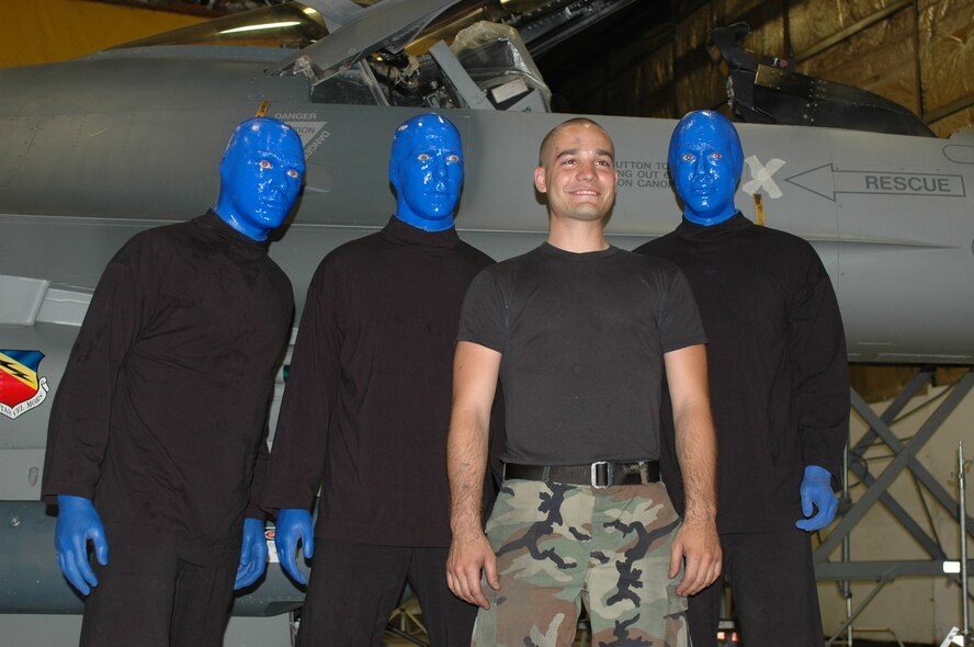 Airman 1st Class John Witlock, 4th Aircraft Maintenance Unit assistant dedicated crew chief, poses with members of the Blue Man Group following filming July 2. The Las Vegas entertainment act visited Hill AFB to shoot a welcome video for Provo, Utah's Stadium of Fire Fourth of July celebration. The 388th Fighter Wing will perform a four-ship flyover at the event to mark the patriotic holiday and thank community members for their support of the Air Force mission. (Photo by 1st Lt. Beth Woodward)