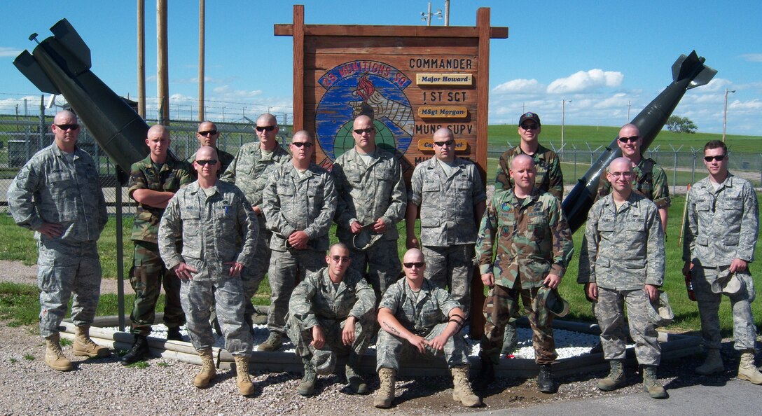 Fourteen members of the 28th Munitions Squadron munitions storage shop shaved their heads after finding out a fellow Airman's mother was diagnosed with breast cancer and undergoing chemotherapy. Their show of support reinforced the unit's devotion to brotherhood and camaraderie. (Courtesy photo/28 MUNS)