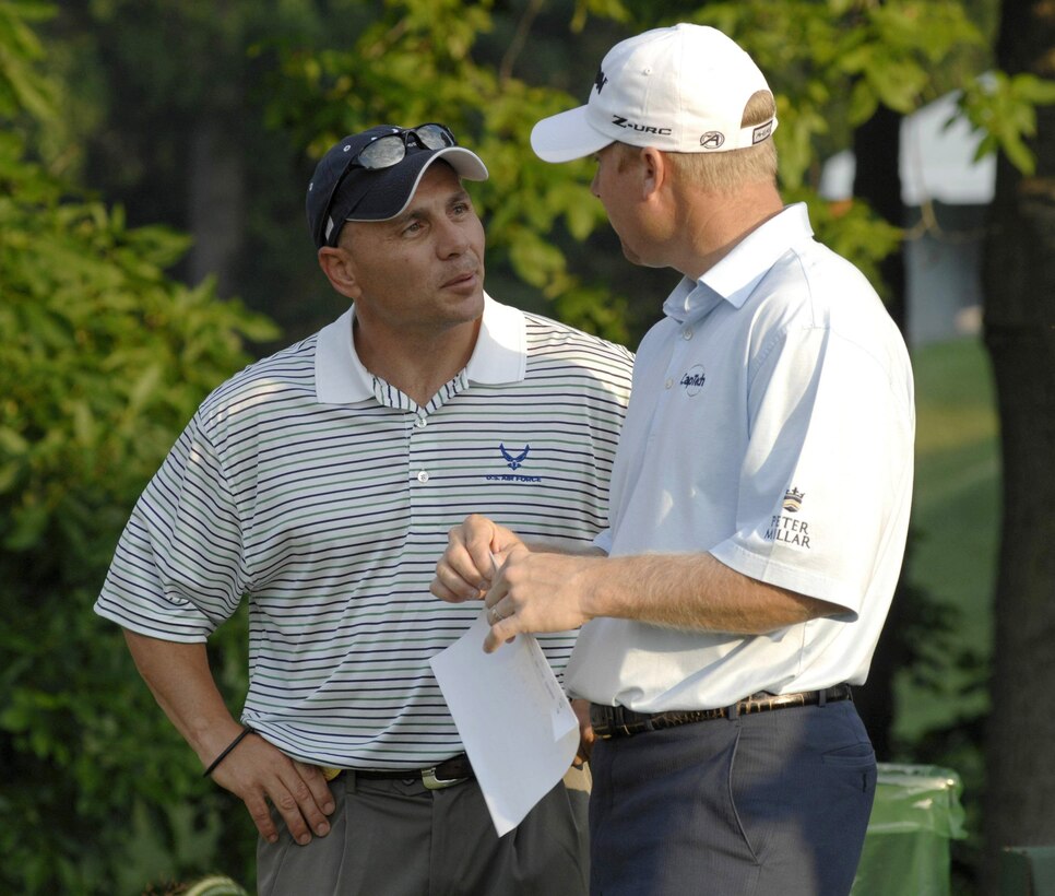 Senior Master Sgt. Kirk Kessler (left) talks with pro golfer John Rollins during the 2nd Annual AT&T National Golf Tournament July 2 at the Congressional Country Club in Bethesda, Md. The Tiger Woods Foundation selected Sergeant Kessler to play in the tournament. Sergeant Kessler is assigned to the 316th Civil Engineer Squadron from Andrews Air Force Base, Md. (U.S. Air Force photo/Senior Airman Steven R. Doty) 