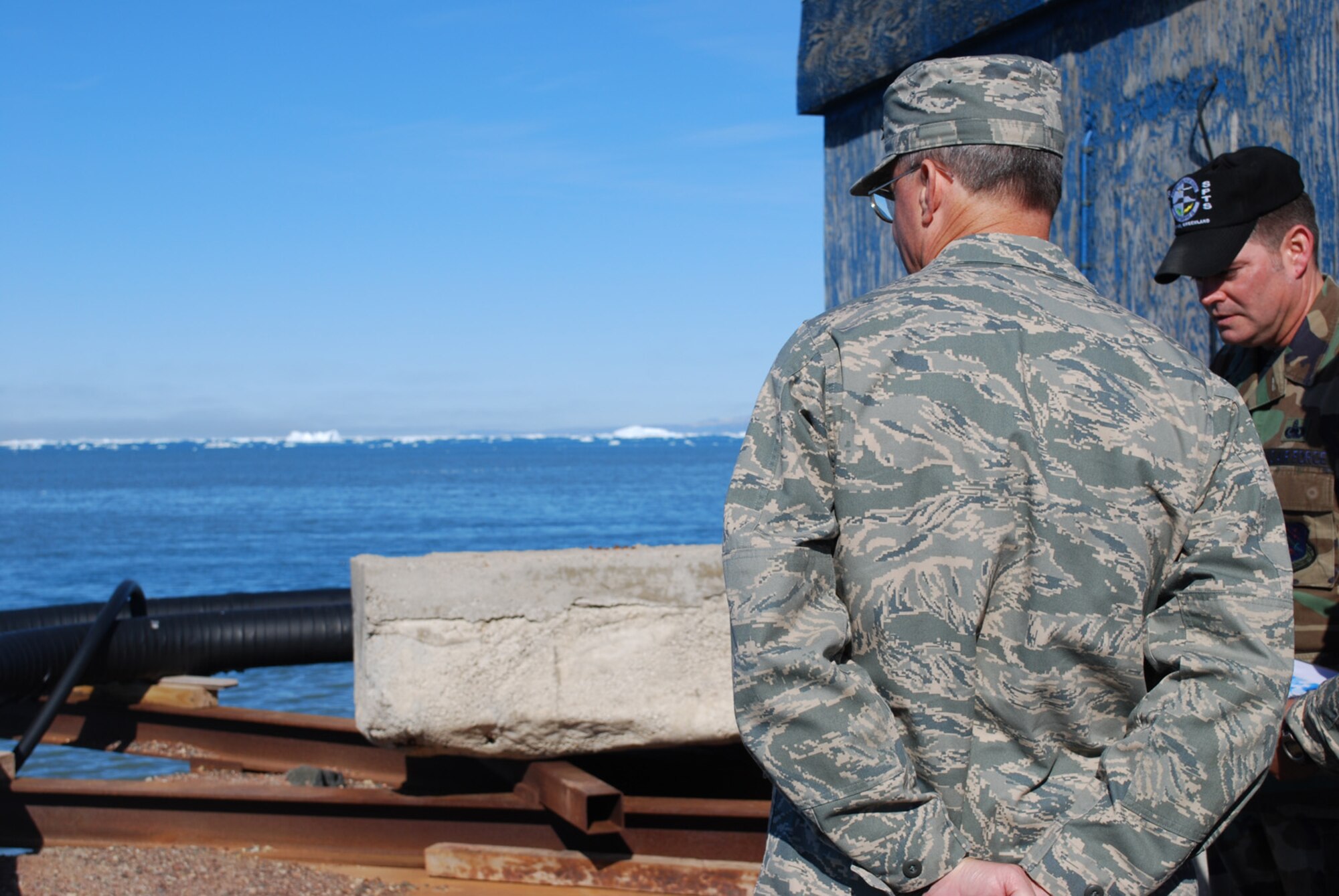 THULE AIR BASE, Greenland – Master Sgt. Timothy Quinn, 821st Support Squadron, points out damage that has occurred to the base’s pier to Gen. Kevin Chilton, commander of U.S. Strategic Command, and explains repair options that are being considered. The general saw firsthand some of the challenges that face the DoD’s northernmost installation during his visit here July 1-2. (U.S. Air Force photo/1st Lt. Nicole Langley)