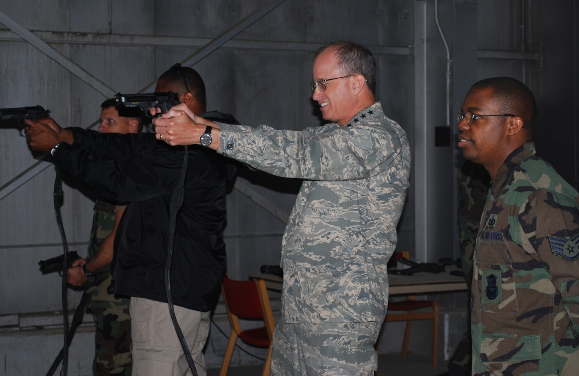 THULE AIR BASE, Greenland – Staff Sgt. Richard Allen, 821st Security Forces Squadron, looks on as Gen. Kevin Chilton, commander of U.S. Strategic Command, fires at the squadron’s new virtual range, the Engagement Skills Trainer 2000, July 2. The general accentuated the importance of having this training capability, which the squadron received in April. “It’s a testament to the team that we got this range up here,” he said. The general visited numerous sites and met members of the multi-national Team Thule during his trip here July 1-2. (U.S. Air Force photo/1st Lt. Nicole Langley).