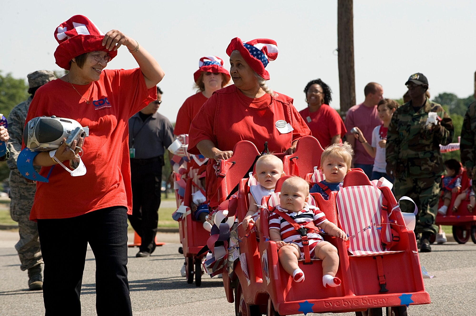 LANGLEY AIR FORCE BASE, Va. -- Childcare providers, children, and parents march in the Red, White and Blue parade outside of the Russ Child Development Center July 3. The CDC holds the parade annually to celebrate Independence Day.  (U.S. Air Force photo/Staff Sgt. Barry Loo)