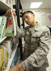 7/2/2008 - Senior Airman Raffy Cartaciano, 37th Aerospace Medicine Squadron, looks up information for a customer July 2. (USAF photo by Robbin Cresswell)