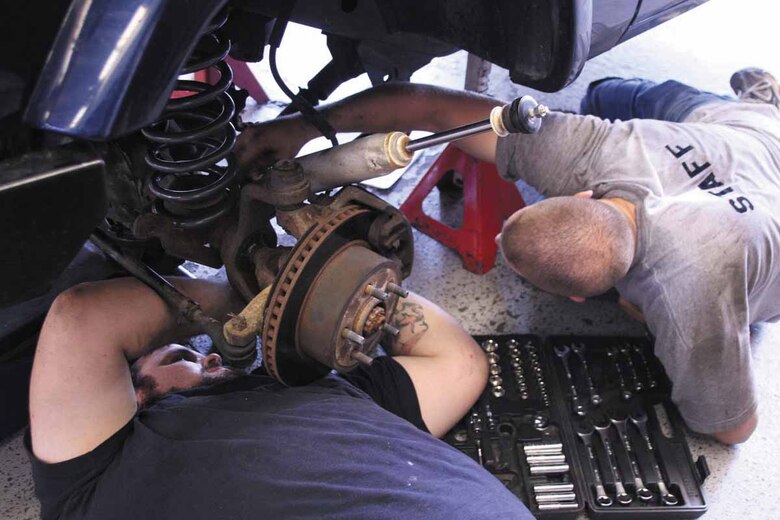 United States Army 2nd Lt. Robert Corless and his brother-in-law  Zack Clark put        3-inch lifts on a Jeep. Lieutenant Corless stopped by Tinker en route to Fort Benning, Ga.  Mr. Clark resides in the local area.  (Air Force photo by Becky Pillifant)