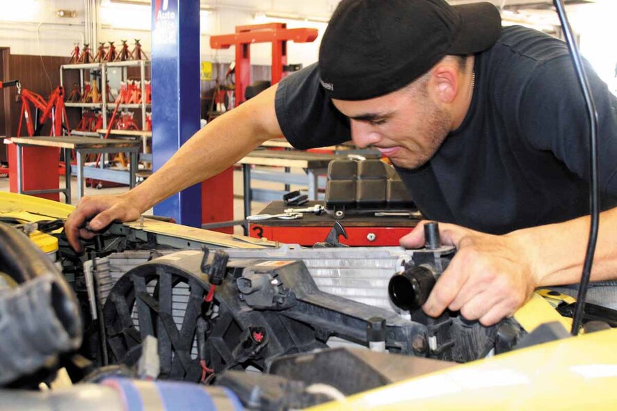 Senior Airman Dennis Martinez, 33rd Combat Communications Squadron, replaces the radiator in his 2002 Mustang at the Auto Hobby Shop.  (Air Force photo by Becky Pillifant)