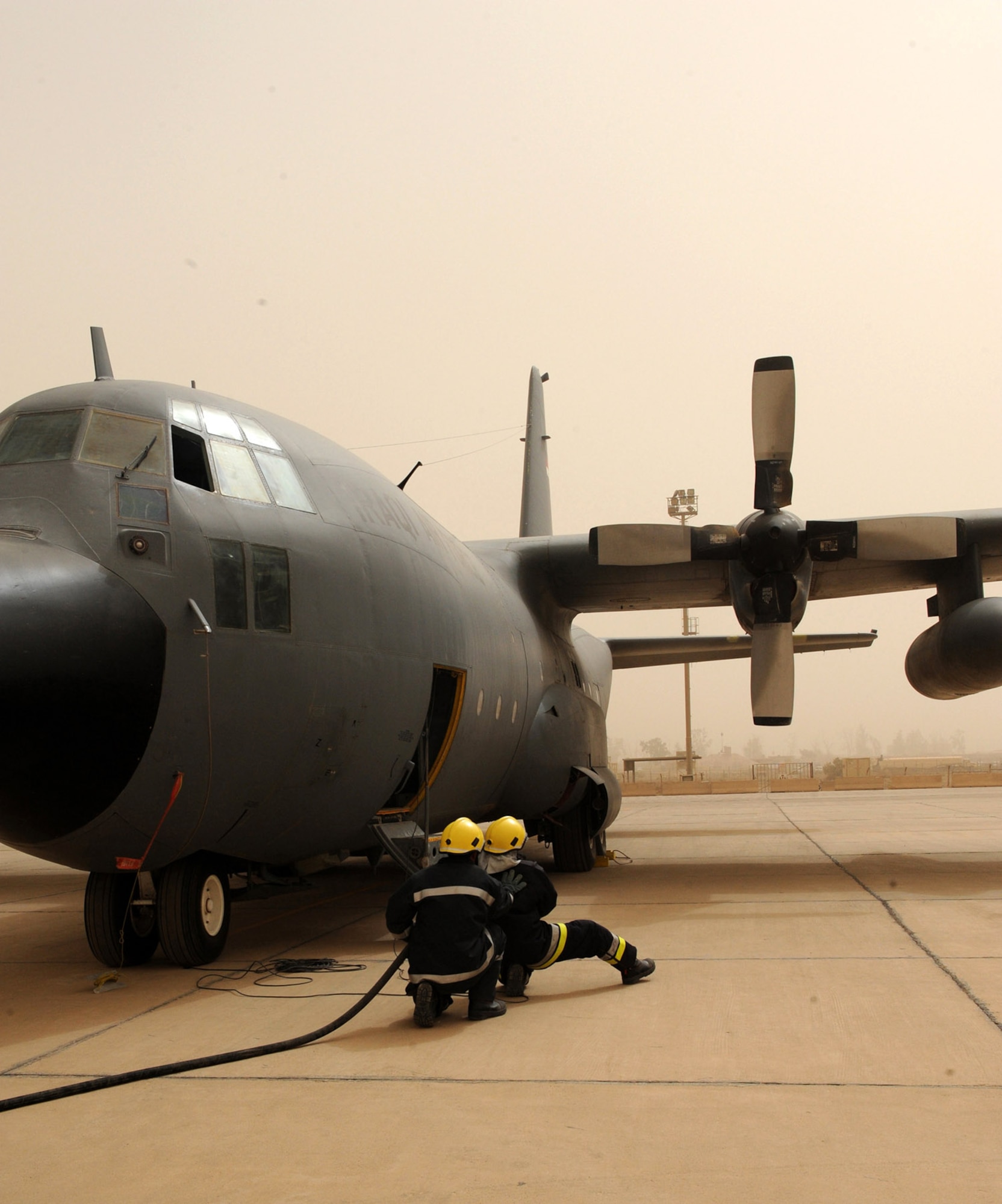 Iraqi firemen respond to a simulated fire on an Iraqi C-130 June 16 at New Al Muthana Air Base, Iraq. The simulation was part of a ground emergency exercise to test the Iraqi's notification and response procedures. (U.S. Air Force photo/Tech. Sgt. Amanda Callahan)