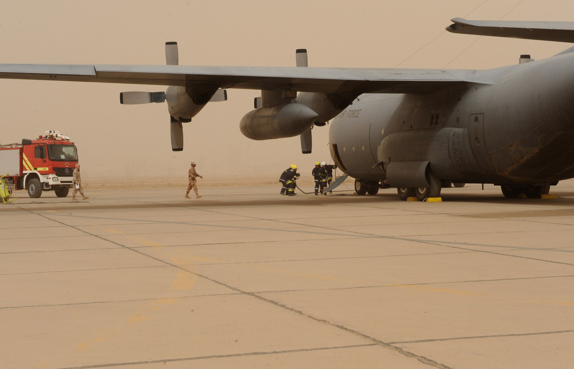 Iraqi firemen respond to a simulated fire on an Iraqi C-130 June 16 at New Al Muthana Air Base, Iraq. The simulation was part of a ground emergency exercise to test the Iraqi's notification and response procedures. (U.S. Air Force photo/Tech. Sgt. Amanda Callahan)