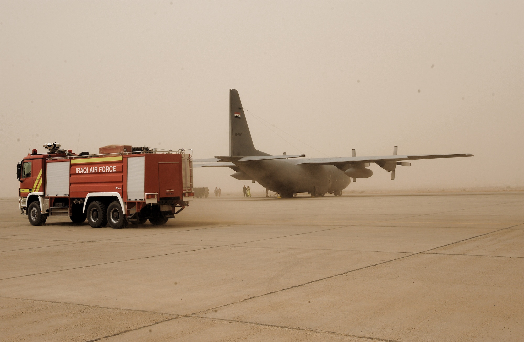 Iraqi firemen respond to a simulated fire on an Iraqi C-130 June 16 at New Al Muthana Air Base, Iraq. The simulation was part of a ground emergency exercise to test the Iraqi's notification and response procedures. (U.S. Air Force photo/Tech. Sgt. Amanda Callahan)