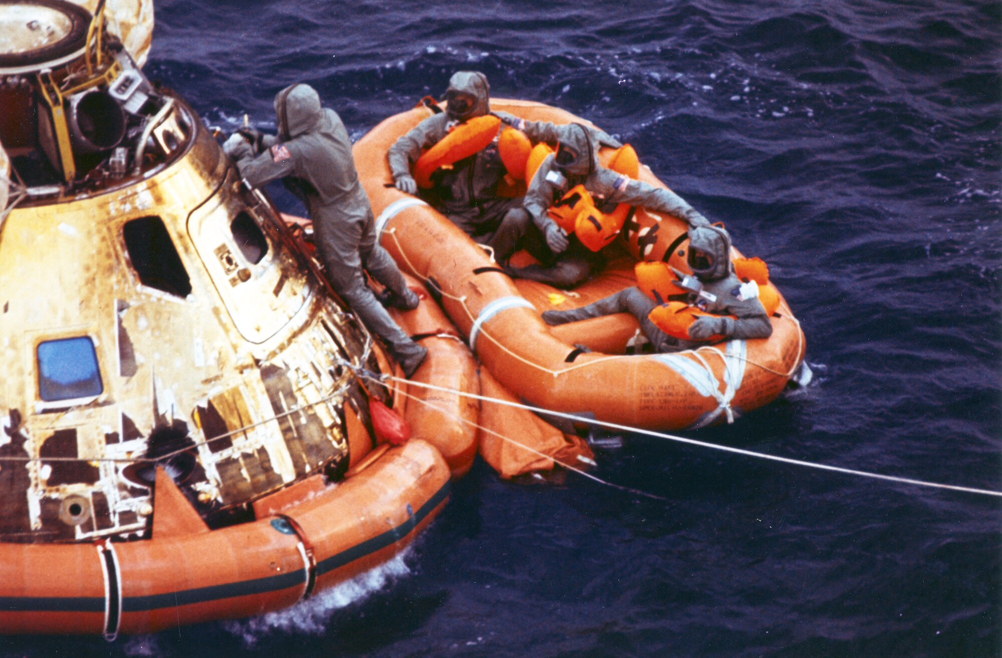 First Lt. Clancy Hatleberg closes the Apollo 11 spacecraft hatch as astronauts Neil Armstrong, Michael Collins and Buzz Aldrin, Jr. await helicopter pickup from their life raft in 1969. The command module moved from Patrick Air Force Base, Fla. for refurbishment was used by pararescuemen to train for both the Apollo and Skylab programs. The 920th Rescue Wing provides emergency medical, rescue and recovery support for all space shuttle and rocket launches. (Photo courtesy of NASA)