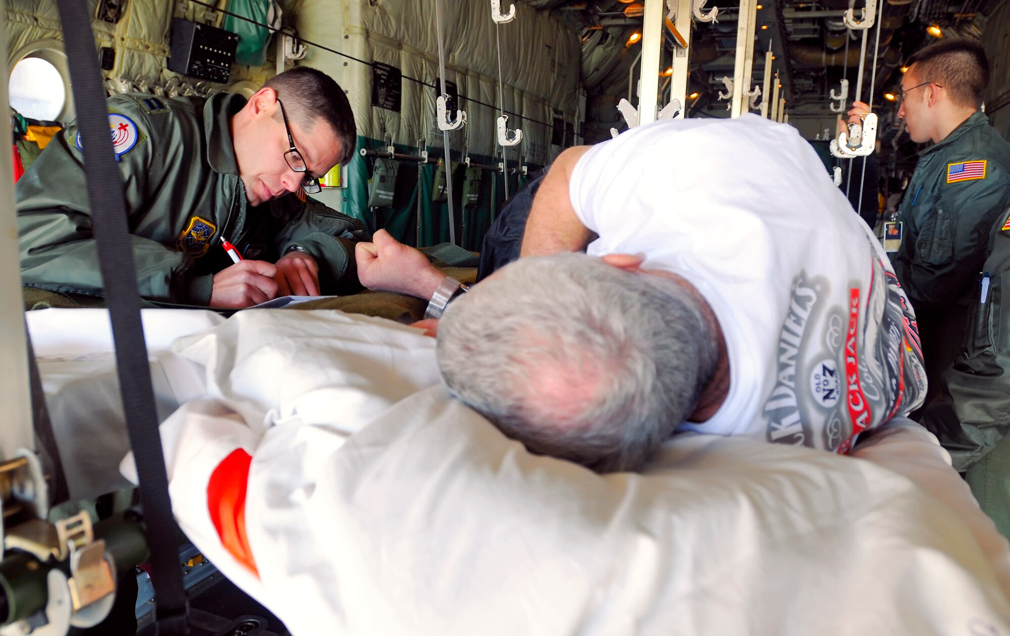 Capt. Kirk Smith records medication provided to a patient during a medical evacuation flight. Captain Smith is a 375th Aeromedical Evacuation Squadron flight nurse from Scott Air Force Base, Ill. (U.S. Air Force photo/Master Sgt. Maurice Hessel) 
