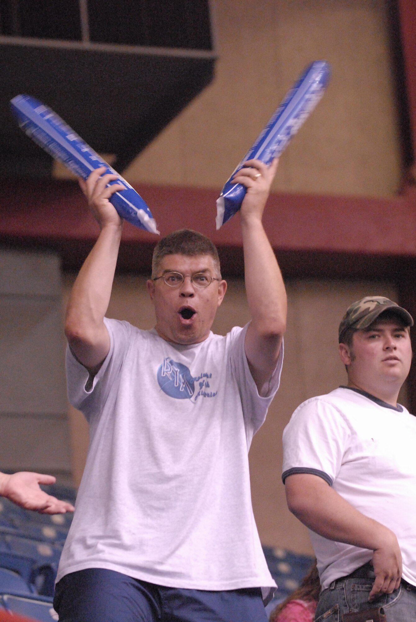 Master Sgt. Russell Howard, first sergeant for the 316th Training Squadron, makes some noise during the San Angelo Stampede Express football game June 28. (U.S. Air Force photo by Master Sgt. Randy Mallard)
