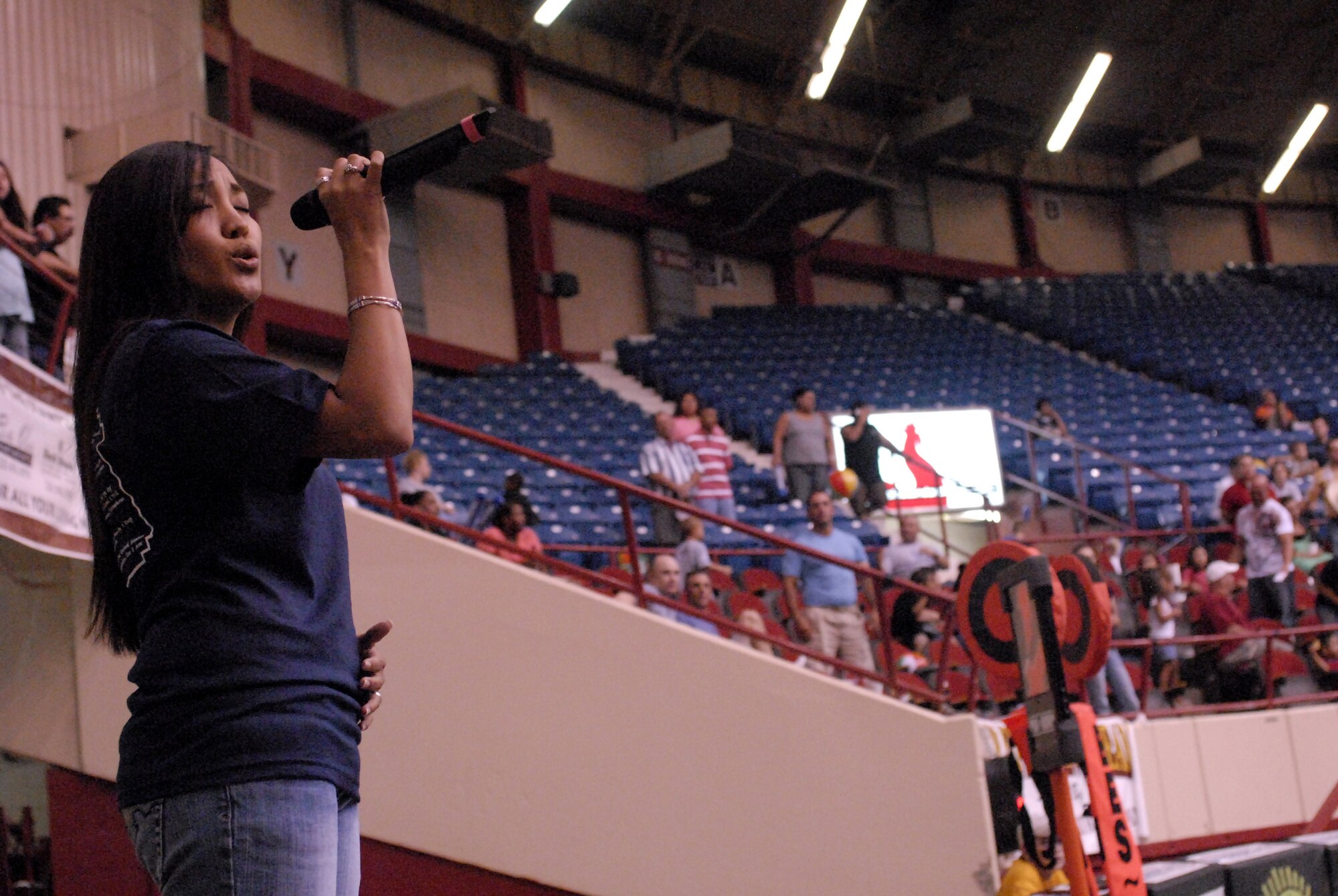 Airman First Class Jennifer Bone sings “Proud to be an American” at the end of halftime at the San Angelo Stampede Express military appreciation night June 28. (U.S. Air Force photo by Master Sgt. Randy Mallard)