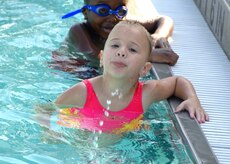 Rachel Darracott squirts water from her mouth at the base swimming pool June 27. Base children joined Rachel in the pool to participate in beginner swimming lessons. Rachel is the 4-year-old daughter of Staff Sgt. Jake Darracott, 437th Aircraft Maintenance Squadron. (U.S. Air Force photo/Airman 1st Class Timothy Taylor)