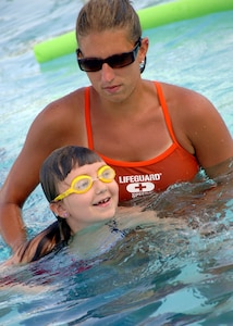 Mrs. Clayton watches Lindsey Baker as she swims freely in the base swimming pool June 27. Mrs. Clayton is a lifeguard and Lindsey is the 8-year-old daughter of Paula Baker, 1st Combat Camera Squadron. (U.S. Air Force photo/Airman 1st Class Timothy Taylor)