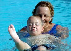 Lori Shimko helps Nolan Huffman swim on his back at the base swimming pool June 27. Mrs. Shimko is a swimming instructor and Nolan is the 4-year-old son of Katie Huffman 437th Operations Support Squadron and Landon Huffman. (U.S. Air Force photo/Airman 1st Class Timothy Taylor)