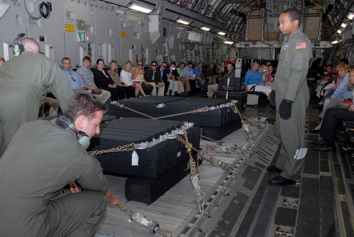 1st Lt. Nick Masters and Airman 1st Class Sean Gilliam prepare a pallet for a combat offload demonstration during the 2008 Leadership Charleston orientation flight July 2. More than 60 civic leaders visited Charleston AFB to learn more about the wing's airlift mission. Lieutenant Masters is a pilot and Airman Gilliam is a loadmaster, both from the 17th Airlift Squadron. (U.S. Air Force photo/Airman 1st Class Cynthia Spalding) 