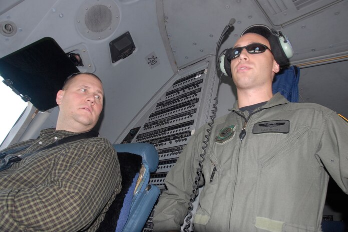 Capt. Dan McVay explains to Geoff Mohney what a pilots job is while in the cockpit of a C-17 July 2. Mohney is one of more than 60 attendees of the 2008 Leadership Charleston C-17 orientation flight. Mohney is with Liollio Architecture and Captain McVay is a 17th Airlift Squadron pilot.  (U.S. Air Force photo/Airman 1st Class Cynthia Spalding) 