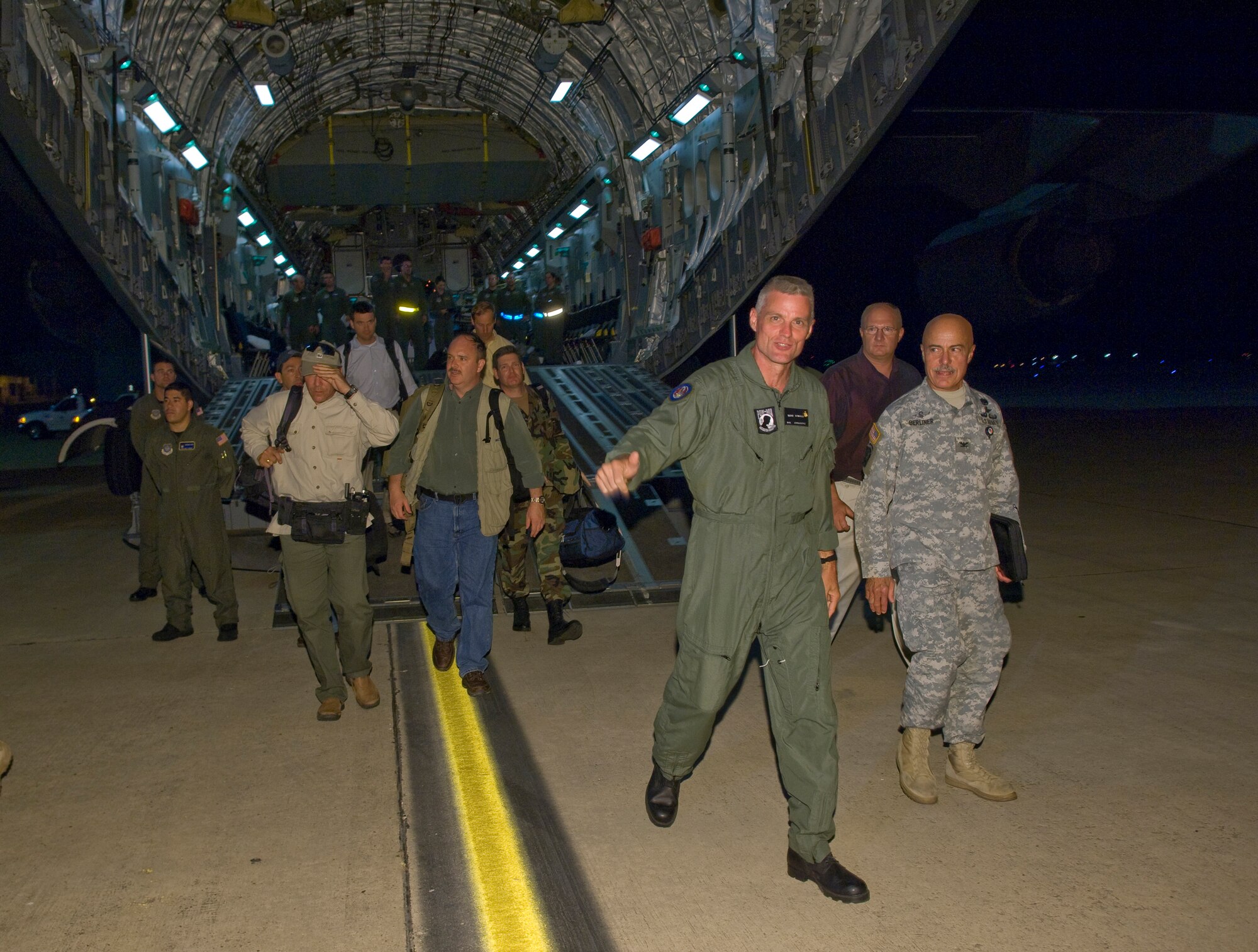 Keith Stansell, a contractor who was rescued after being held hostage by rebels in Colombia, steps off the ramp of a C-17 Globemaster III onto U.S. soil at Lackland Air Force Base, Texas at 11:31 p.m., July 2. The aircraft is stationed at Travis AFB, Calif., and the crews came from various bases such as Charleston AFB, S.C., and Pope AFB, N.C.  (U.S. Air Force photo/Lance Cheung)