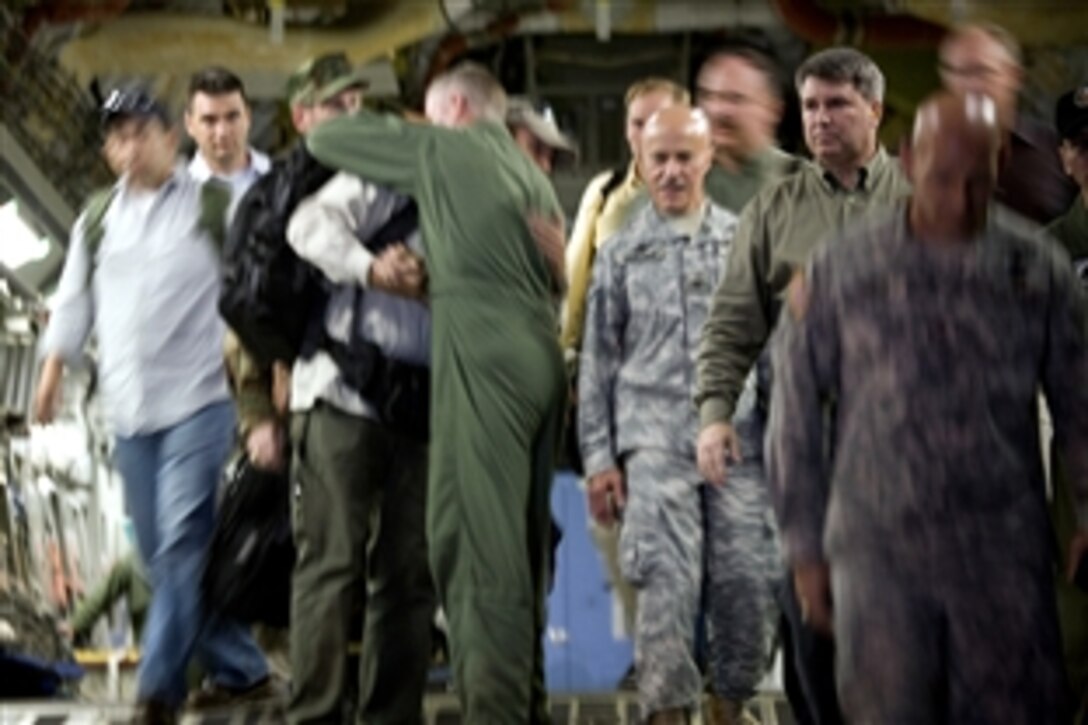 At the top of the cargo ramp of a C-17 Globemaster III, Keith Stansell hugs one of the people who helped him return to the United States on Lackland Air Force Base, Texas, July 2, 2008. The contractor was one of three Americans rescued after being held captive by the Revolutionary Armed Forces of Colombia for five years. 
