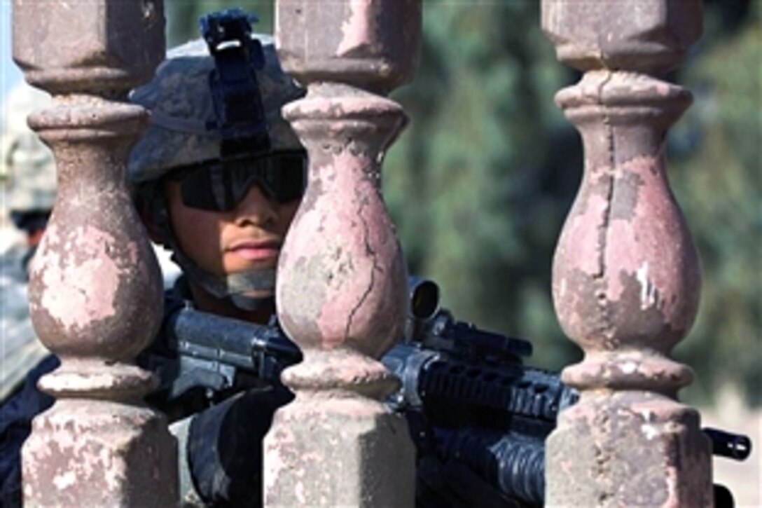 A U.S. Army soldier stands guard just inside a compound in the city of Khanaqin, Iraq, June 29, 2008. The soldier is assigned to the Troop F, 2nd Squadron, 3rd Armored Cavalry Regiment. 
