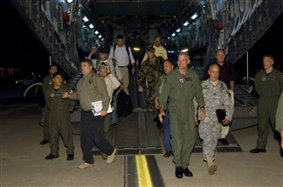 Keith Stansell (4th from the right) steps off the ramp of a C-17 Globemaster III onto U.S. soil at Lackland Air Force Base, Texas, on July 2, 2008.  Stansell and two other U.S. government contractors were rescued by Colombian security forces after being held captive by the Revolutionary Armed Forces of Columbia, or FARC, since their plane crashed in a remote area in February 2003.  