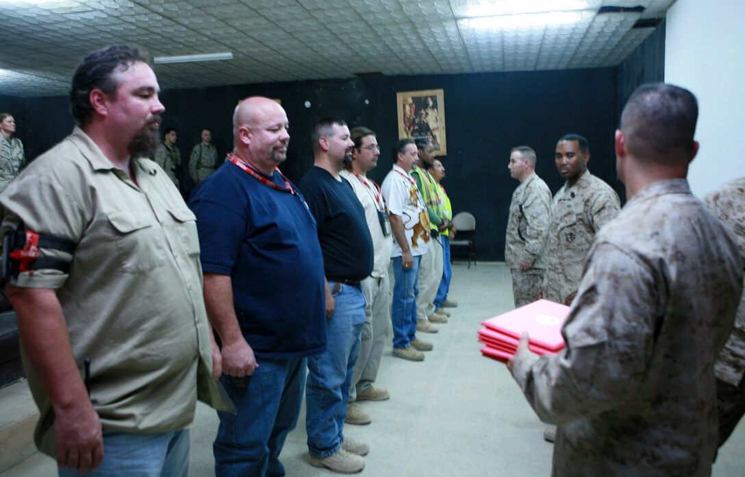 FALLUJAH, Iraq (July 4, 2008) -Civilian contractors who support Combat Logistics Battalion 1, 1st Marine Logistics Group were awarded Certificates of Appreciation here, July 4. The contractors were handed their awards by CLB-1's Commanding Officer, Lt. Col. David Nathanson, who thanked them for their service and support to all the Marines they work with. (Photo by Lance Cpl. Cindy G. Alejandrez)