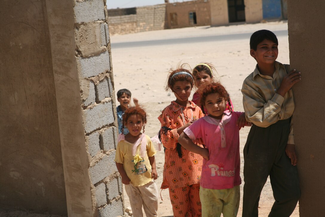 Local Iraqi children from the Abu Saleh area of Fallujah, play together July 5, near their school where they attend classes during the school year. Marines with Detachment 3, Civil Affairs Group 3, Regimental Combat Team 1, oversee the construction project of this local communities school being rebuilt.