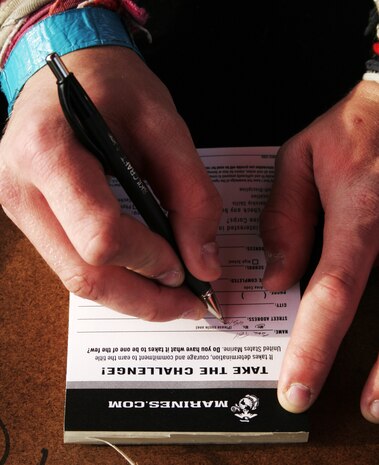 A participant of the Marine pull-up challenge July 6 at Summerfest fills out an event card to receive further information about the Marine Corps. 1,971 event cards were completed, which resulted in one contract and 380 age/education qualified leads. Marines challenged the music festival attendees to either perform a max set of pull-ups or a flexed-arm hang as long as possible to raise awareness of the Marine Corps.