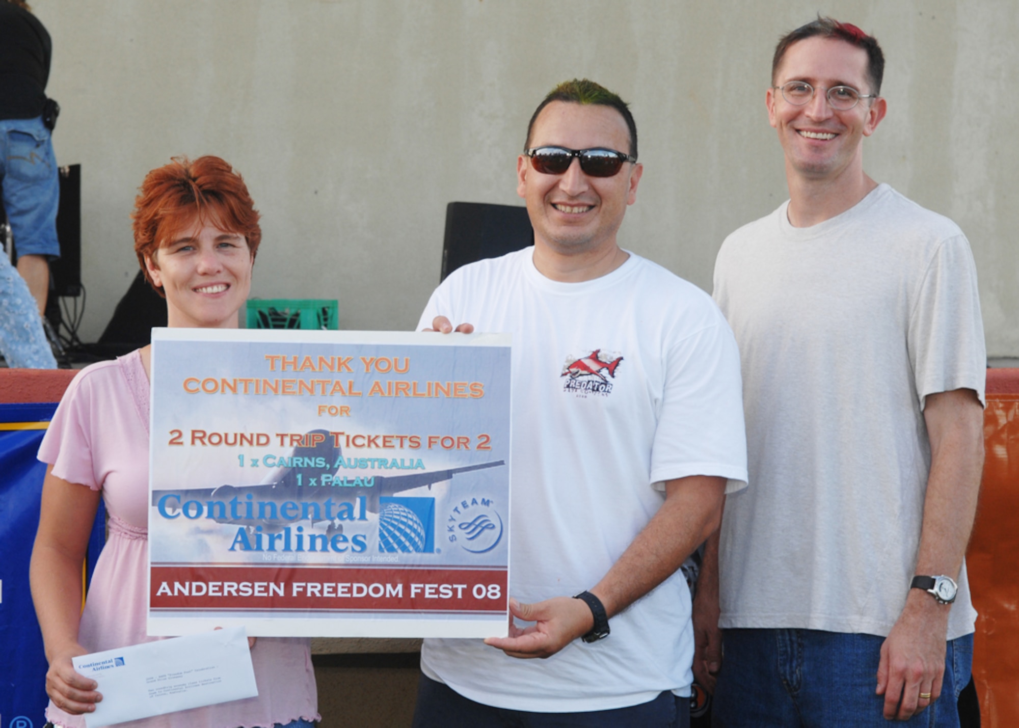 Linda McClung, wife of TSgt Lewis McClung of the 734th Air Mobility Squadron and William Loahan of the 36th Medical Group won the grand prize trips for two to Cairnas, Australia and Palau during Freedom Fest at Arc Light Park here July 3. Freedom Fest is hosted by the 36th Force Support Squadron and held annually to recognize and celebrate our Independence Day. (U.S. Air Force photo by Airman 1st Class Nichelle Griffiths)