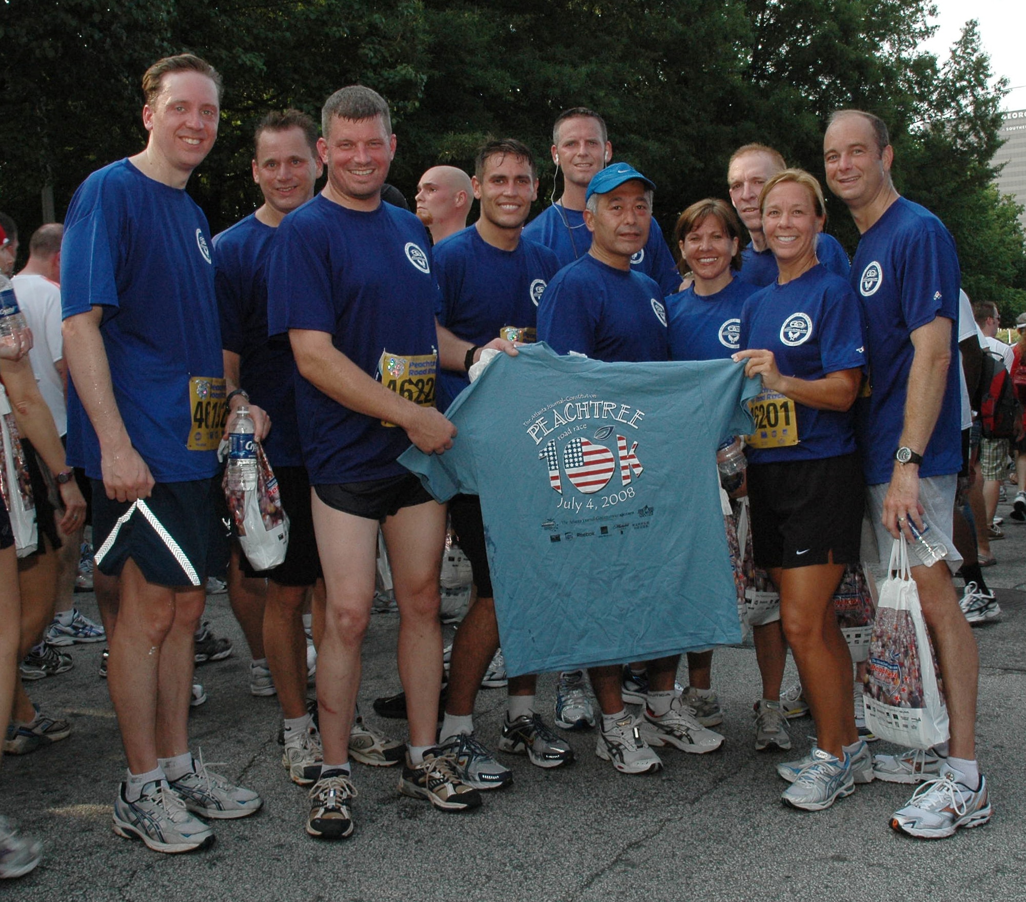 Members of the 2008 Dobbins Air Reserve Base Running Team Proudly display a member's 6-mile earned coveted Atlanta Peachtree Road Race T-Shirt on July 4, 2008.  The team's T-shirt. worn during the race, was designed in honor of the 60th Anniversary of the Air Force Reserve. (U.S. Air Force photo/Master Sgt. Stan Coleman)