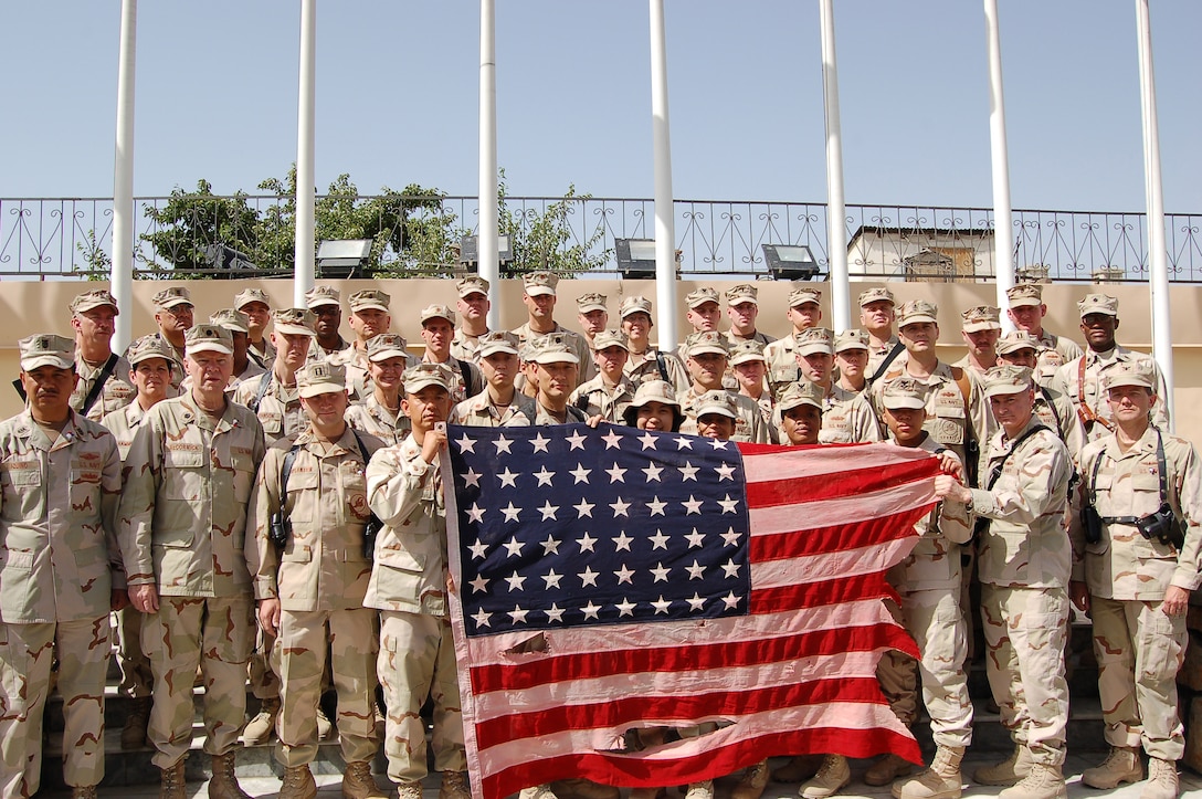 A group of sailors from the Combined Security Transition Command-Afghanistan hold an American flag with 48 stars July 4, 2008, after it was flown over Camp Eggers in Kabul, Afghanistan. Retired Navy Cmdr. Joseph Agra III acquired the flag in 2000 after a fisherman retrieved it from the water off the coast of the Bataan Penninsula in the Philippines. Agra has carried the flag to several locations and has flown it over camps in Kuwait, Iraq and Afghanistan. Defense Dept. photo by Air Force Staff Sgt. Beth Del Vecchio