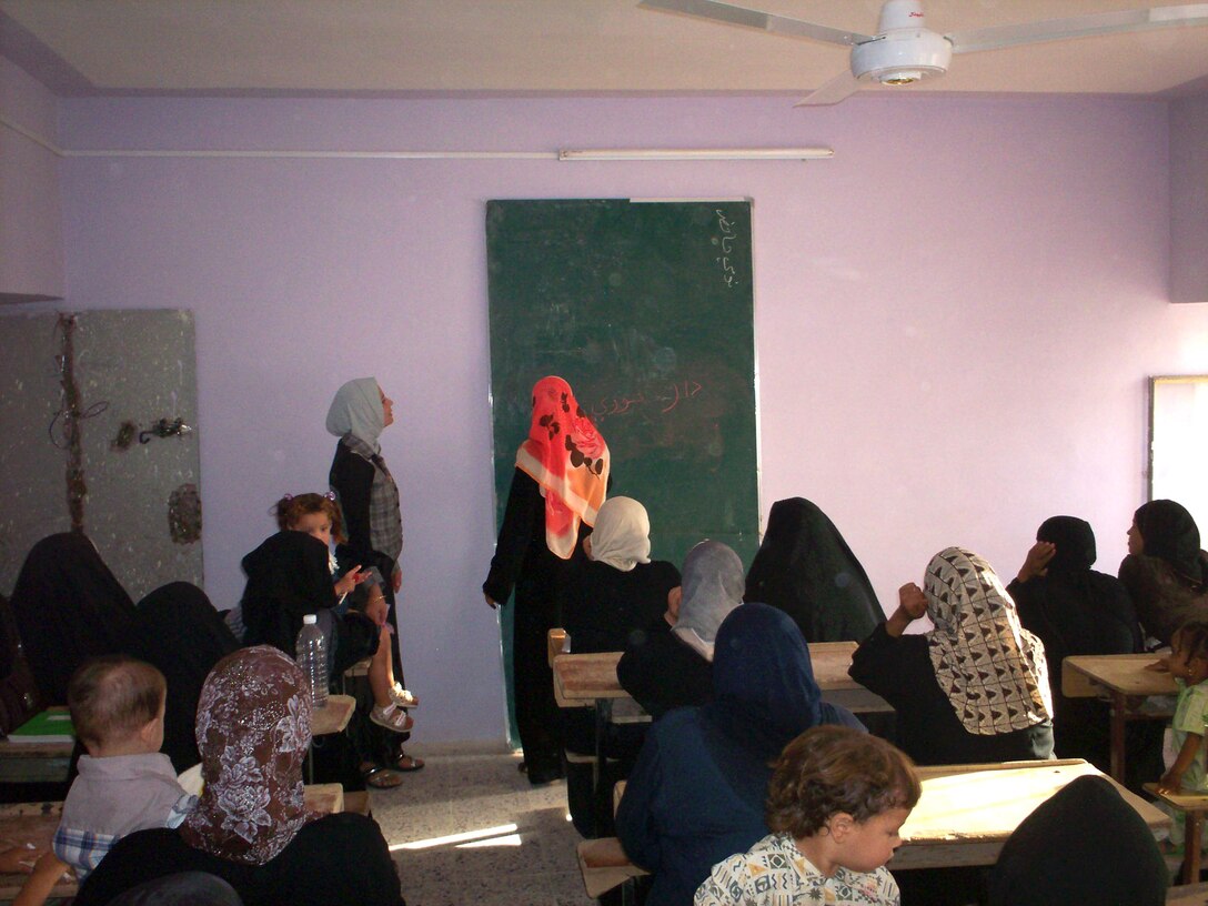 RAMADI, Iraq (July 8, 2008) - An instructor for the Women’s Literacy Program in Ramadi teaches a class of women July 6. The program’s classes are held daily at four locations in the city and are designed to teach illiterate women how to read and write Arabic, while also teaching more educated women the fundamentals of English.