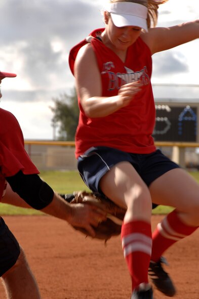 Lady Bombers Sabel Sisney avoids a tag out at third at this years Firecracker Classic softball tournament on Andersen, July 4. The Lady Bombers were the host team for this years tournament. (U.S. Air Force photo by Airman 1st Class Courtney Witt) 